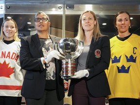 Team Canada’s Sarah Fillier, left, Angela James, second left, HHOF 2010, GM of Toronto Six and Jayna Hefford, second right, HHOF 2018, Chairperson, PWHPA and Team Sweden’s Anna Kjellbin pose with a trophy at the Hockey Hall of Fame in Toronto on Tuesday, April 4, 2023. The Hockey Hall of Fame opened an exhibit dedicated to the trailblazers of the women’s game chronicling their remarkable journey spanning more than 130 years. Over 100 artifacts will be installed to tell their story.