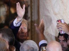 Former President Donald Trump waves to supporters after speaking at his Mar-a-Lago estate hours after being arraigned in New York City, Tuesday, April 4, 2023, in Palm Beach, Fla.