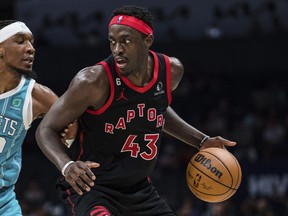 Charlotte Hornets' Xavier Sneed (left) guards Raptors' Pascal Siakam during the second half in Charlotte, N.C., Tuesday, April 4, 2023.