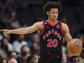 Toronto Raptors guard Jeff Dowtin Jr. directs a play against the Charlotte Hornets during the second half of an NBA basketball game in Charlotte, N.C., Tuesday, April 4, 2023.