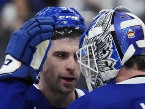 Maple Leafs' John Tavares celebrates with goaltender Joseph Woll after defeating the Columbus Blue Jackets in Toronto on Tuesday, April 4, 2023.