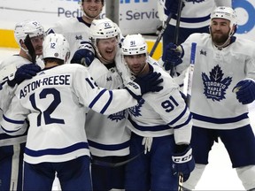 Maple Leafs' John Tavares celebrates with his teammates after scoring the game-winning goal during overtime against the Florida Panthers, Monday, April 10, 2023, in Sunrise, Fla.