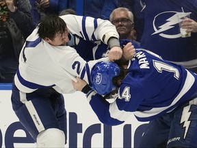 Maple Leafs' Luke Schenn (left) and Tampa Bay Lightning's Pat Maroon fight during the first period of a game Tuesday, April 11, 2023, in Tampa, Fla.