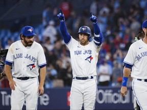 Blue Jays' George Springer celebrates with teammates after hitting a walk-off single to defeat the Detroit Tigers 4-3 in Toronto on Wednesday, April 13, 2023.