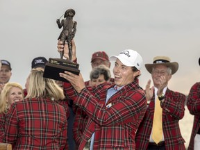 Matt Fitzpatrick, of England, holds the championship trophy after a three-hole playoff during the final round of the RBC Heritage golf tournament, Sunday, April 16, 2023, in Hilton Head Island, S.C.