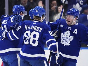 Maple Leafs defenceman Morgan Rielly (right) joins in the celebration after setting up John Tavares for a goal in last night's 7-2 romp over Tampa Bay at Scotiabank Arena. Rielly assisted the first four Leafs goals in perhaps his finest game in the NHL.
