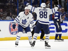 Toronto Maple Leafs defenseman Morgan Rielly celebrates his game-winning goal against the Tampa Bay Lightning with right wing William Nylander during overtime in Game 3 of an NHL hockey Stanley Cup first-round playoff series Saturday, April 22, 2023, in Tampa, Fla.