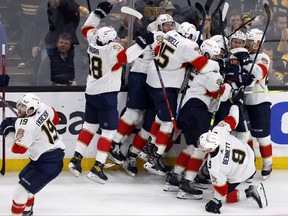 The Florida Panthers celebrate after defeating the Boston Bruins on a goal by Carter Verhaeghe in overtime during Game 7 of their first-round playoff series, Sunday, April 30, 2023, in Boston.