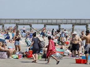 In this file photo taken on March 20, 2020, beach goers enjoy the Isle of Palms beach in Isle of Palms, S.C.