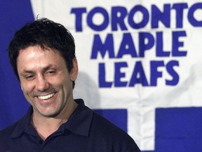 Maple Leafs' Doug Gilmour smiles as he answers questions at a news conference after arriving in Calgary, Wednesday, March 12, 2003.