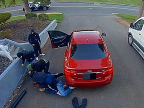 A homeowner confronts one suspect - which turns in four suspects - and is attacked by all four, during a reported burglary of a motor vehicle on a driveway in Rocky Hill, Connecticut. Police are looking for four suspects who got away in a dark blue or black four door Mercedes sedan. Video screenshot/Rocky Hill Police Department CT