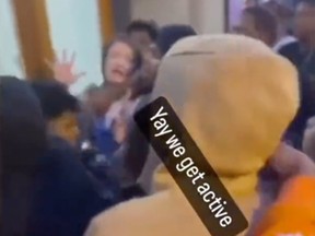 A woman is swarmed by large group of people and appears to be assaulted in Chicago in a video circulating on social media. Twitter screenshot.