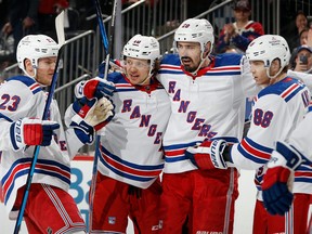 Left to right: Adam Fox, Artemi Panarin, Chris Kreider and Patrick Kane of the New York Rangers celebrate a third period powerplay goal by Kreider against the New Jersey Devils during Game 1 in the First Round of the 2023 Stanley Cup Playoffs at the Prudential Center on April 18, 2023 in Newark, N.J.