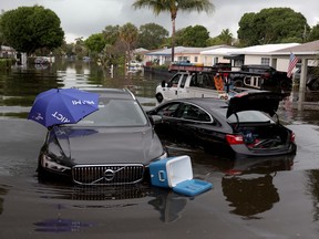 Abandoned vehicles sit in a flooded street on April 13, 2023 in Fort Lauderdale, Florida.