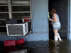 Tammy Green walks into the home she lives in with her dad, who is a military veteran, after flood waters inundated it on April 14, 2023 in Fort Lauderdale, Florida.