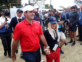 Patrick Reed of the United States team and wife Justine celebrate after they won the Presidents Cup 16-14 on day four of the 2019 Presidents Cup at Royal Melbourne Golf Course on December 15, 2019 in Melbourne, Australia.