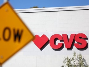 A sign is posted on the exterior of a CVS Pharmacy on Jan. 27, 2023 in Half Moon Bay, Calif.
