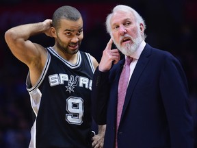 Tony Parker of the San Antonio Spurs talks with head coach Gregg Popovich at Staples Center on December 22, 2016 in Los Angeles.