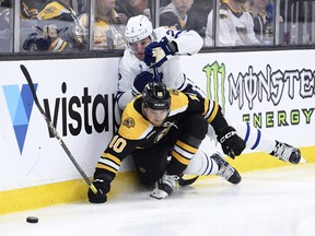 Maple Leafs' Luke Schenn (top) and Bruins' A.J. Greer battle along the boards during the third period at TD Garden in Boston on Thursday, April 6, 2023.