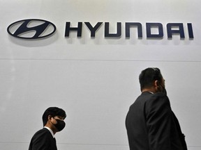 Visitors walk past the logo of Hyundai during a press preview of the 2023 Seoul Mobility Show at the KINTEX exhibition hall in Goyang, South Korea, March 30, 2023.