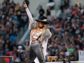 Trish Stratus acknowledges the crowd before her tag team match at WrestleMania 39.