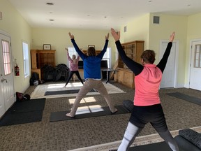 A yoga class by Tanya Bent of Evolve Wellness sees Joey Filippone and Diance Jackson limbering up before golf at Black Bear Ridge. (Jane Stevenson/Toronto Sun)
