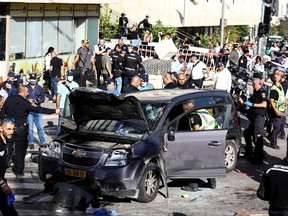 Israeli security forces and rescue workers work at the scene following an incident by Jerusalem's main market, April 24, 2023.