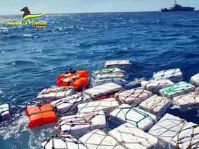 This undated and unlocated photo issued as a handout on April 17, 2023 by the Italian Guardia di Finanza (GdF) law enforcement agency, shows packages of cocaine floating off Sicily's eastern coast, during an interception by GdF police officers.