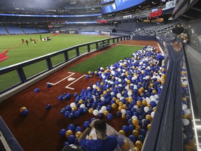 The Toronto Blue Jays unveiled Phase One of their “Next Level” renovations of Rogers Centre with an Open House in advance of the Blue Jays home opening game against the Detroit Tigers on April 11 (Pictured) Attendees bag up all the ceremonial balloons that fell into the new raised visitors bullpen that puts fans up close and personal. in Toronto, Ont. on Thursday April 6, 2023. Jack Boland/Toronto Sun