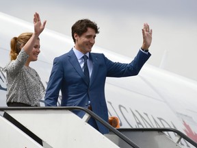 Canada's Prime Minister Justin Trudeau (R) and his wife Sophie Gregoire wave after disembarking from their plane upon arrival in Mexico City on October 12, 2017. RONALDO SCHEMIDT/AFP via Getty Images