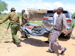 Kenya police officers and civilians rescue an emaciated member of a Christian cult named as Good News International Church, whose members believed they would go to heaven if they starved themselves to death, in Shakahola forest of Kilifi county, Kenya April 24, 2023.