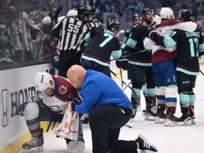 Colorado Avalanche head athletic trainer Matt Sokolowski tends to center Andrew Cogliano (11) during the second period against the Seattle Kraken in game six of the first round of the 2023 Stanely Cup Playoffs at Climate Pledge Arena.