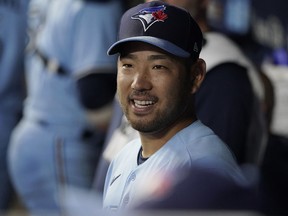 Yusei Kikuchi of the Toronto Blue Jays waits to greet teammates in the dugout in the fifth inning against the Kansas City Royals at Kauffman Stadium on April 4, 2023 in Kansas City.