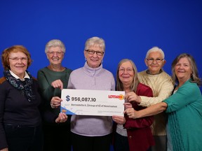 Six (of eight) retired former co-workers hold up OLG cheque worth $956,087.10.