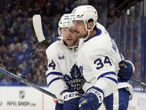 Toronto Maple Leafs centre Auston Matthews (34) celebrates his goal against the Tampa Bay Lightning with defenceman Morgan Rielly (44) during the third period in Game 4 of an NHL hockey Stanley Cup first-round playoff series Monday, April 24, 2023, in Tampa, Fla.