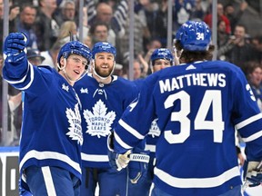 Maple Leafs forward Mitch Marner (left) celebrates with forwards Ryan O'Reilly (90) and Auston Matthews (34) after scoring against the Canadiens in the first period at Scotiabank Arena in Toronto, Saturday, April 8, 2023.