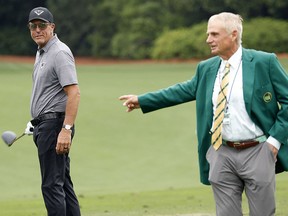 Phil Mickelson of the U.S. speaks with a member of Augusta National, Jimmy Dunne, on the practice range during a practice round April 4, 2023.