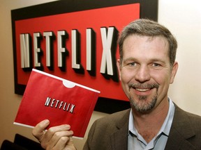 Reed Hastings, founder and CEO of Netflix, holds one of the envelopes used by Netflix to ship DVDs to members at his office in Beverly Hills, Calif., Dec. 10, 2004.
