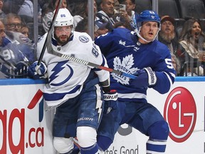 Lightning forward Nikita Kucherov (86) collides along the boards with Maple Leafs forward Noel Acciari (52) during Game One of the First Round of the Stanley Cup Playoffs at Scotiabank Arena in Toronto, Tuesday, April 18, 2023.
