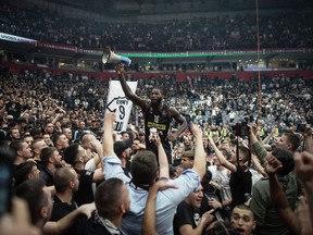 Partizan's French player Mathias Lessort (centre) celebrates their victory with fans after the EuroLeague basketball match between KK Partizan Belgrade and Olympiacos in Belgrade, on March 24, 2023.