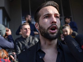 Tristan Tate is surrounded by media as he leaves the building that houses the Directorate for Investigating Organized Crime and Terrorism (DIICOT) in Bucharest, Romania, April 10, 2023.