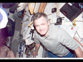 Astronaut Marc Garneau, mission specialist representing the Canadian Space Agency (CSA), poses for a photograph onboard the mid-deck of the Earth-orbiting Space Shuttle Endeavour. The scene was recorded with an Electronic Still Camera (ESC).