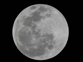 A full moon is seen over Mexico City April 5, 2023.