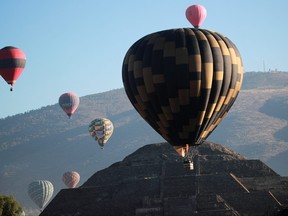 In this file photo, hot air balloons float near the Pyramid of the Moon on the day of the spring equinox in the pre-hispanic city of Teotihuacan, on the outskirts of Mexico City, March 20, 2023.