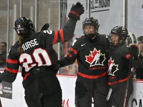 Team Canada forward Sarah Fillier (right) celebrates a goal against Switzerland with forwards Sarah Nurse (left) and Natalie Spooner (centre) in the third period at the CAA Center in Brampton, Ont., Wednesday, April 5, 2023.