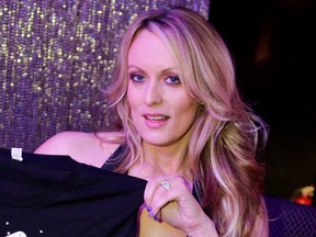 Adult film actress Stephanie Clifford, also known as Stormy Daniels, poses for pictures at the end of her striptease show in Gossip Gentleman club in Long Island, N.Y., Feb. 23, 2018.