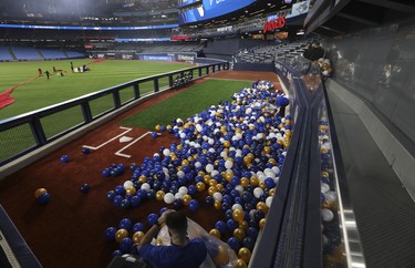 TheÊToronto Blue JaysÊunveiled Phase One of their ÒNext LevelÓ renovations of Rogers Centre with an Open House in advance of the Blue Jays home opening game against the Detroit Tigers on April 11 (Pictured) Attendees bag up all the ceremonial balloons that fell into the new raised visitors bullpen that puts fans up close and personal. in Toronto, Ont. on Thursday April 6, 2023. Jack Boland/Toronto Sun/Postmedia Network