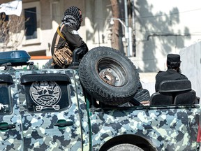 Taliban security personnel sit in a vehicle in Kabul on March 27, 2023.