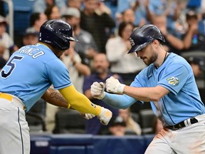 Brandon Lowe #8 celebrates with Wander Franco #5 of the Tampa Bay Rays after hitting a home run in the seventh inning against the Boston Red Sox at Tropicana Field on Thursday.