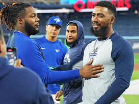 Mariners right fielder Teoscar Hernandez (right) greets Toronto Blue Jays first baseman Vladimir Guerrero Jr. (left) during batting practice prior to their game at Rogers Centre.